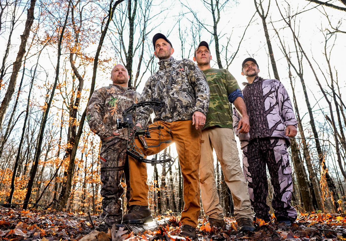 Melillo (holding bow) with Wayne Davis (second from right), who helped track the bear, and hunting buddies Marc Yodice and Jason Famularo.